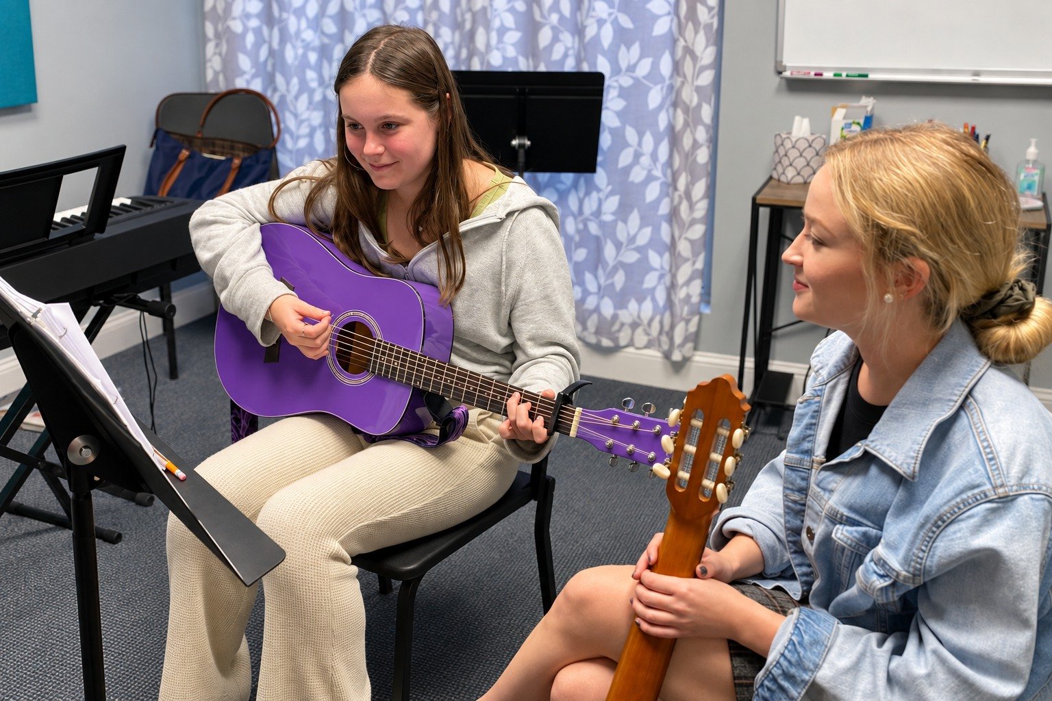 A Thrive guitar student practicing with individual guidance from an instructor