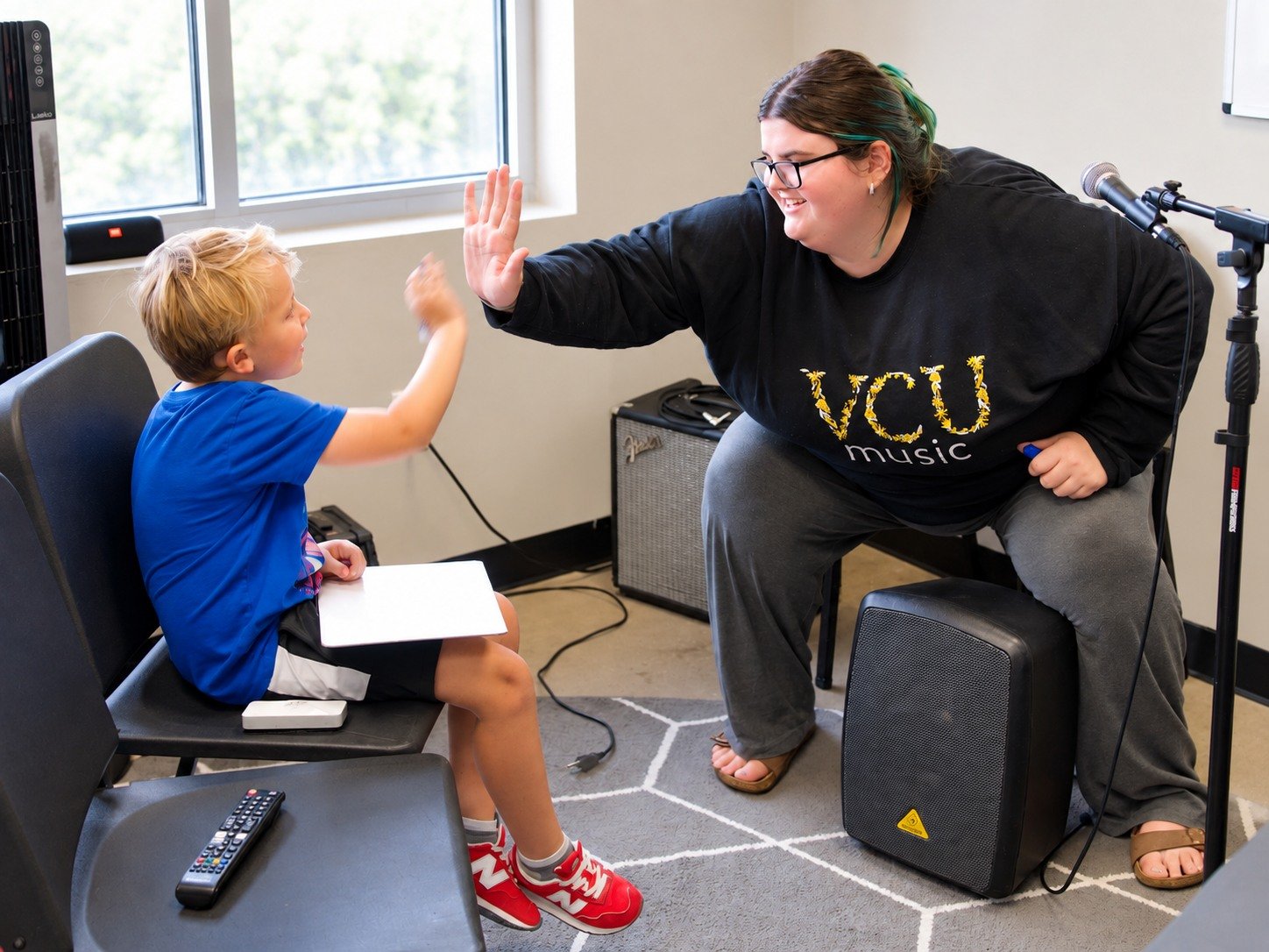 A Thrive instructor and student celebrating progress with a high-five